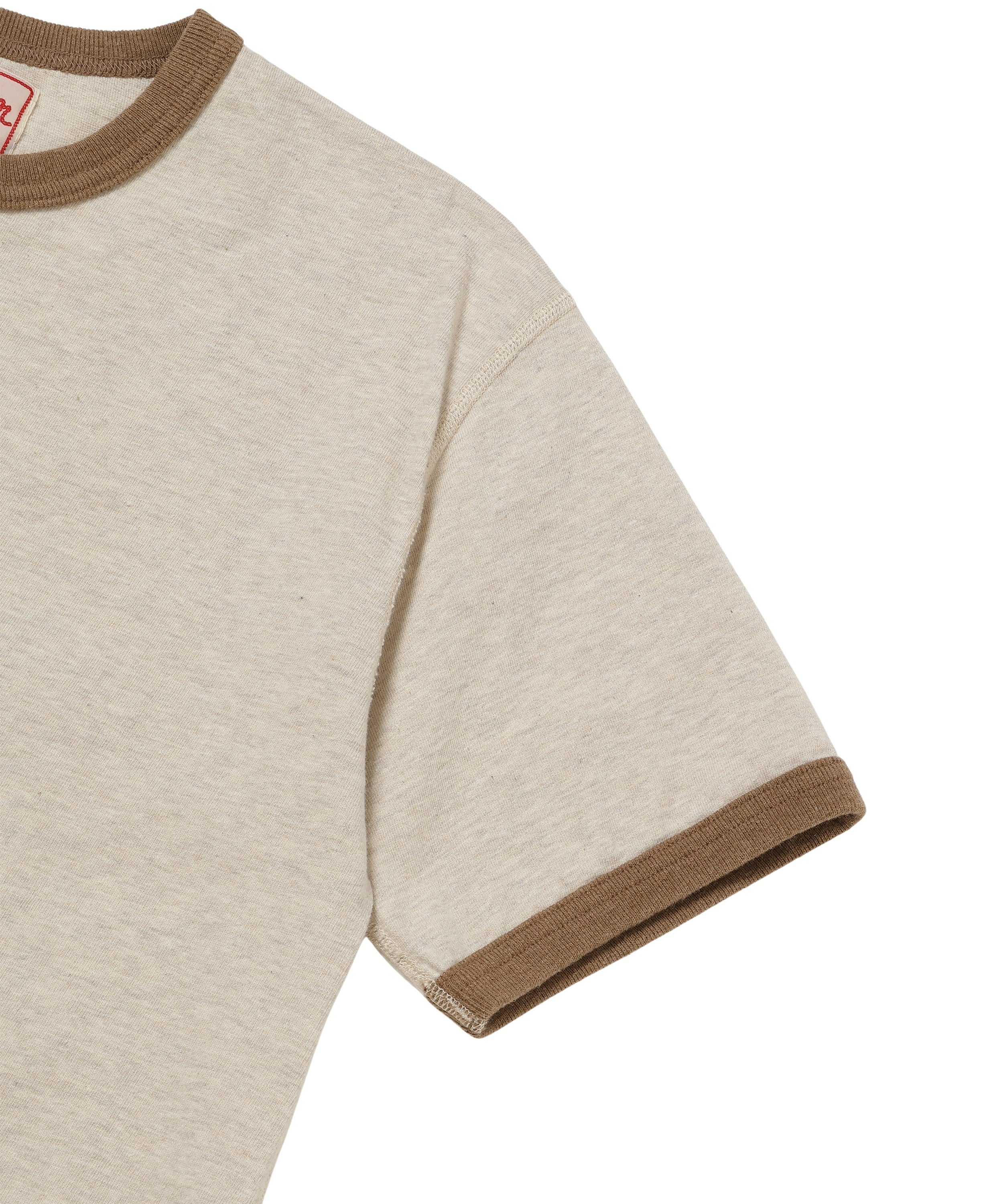 Close-up of recycled cotton ringer t-shirt, front right shoulder and sleeve, stone color, brown collar and cuff details.