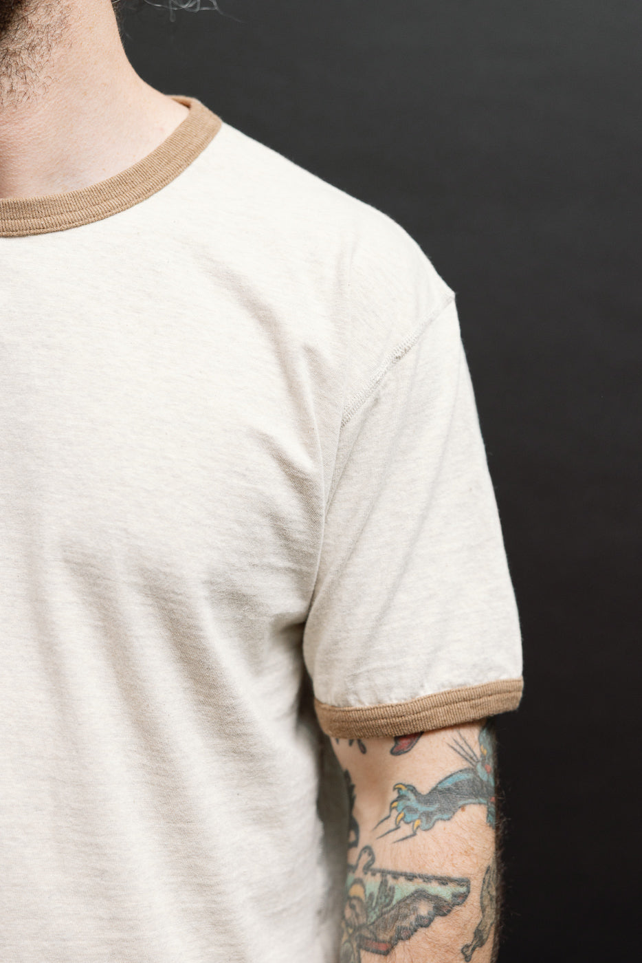 Close-up left side view of a cream t-shirt on a 5'9
