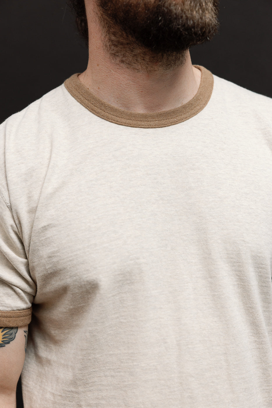 Close-up front view of a cream ringer t-shirt on a 5'9