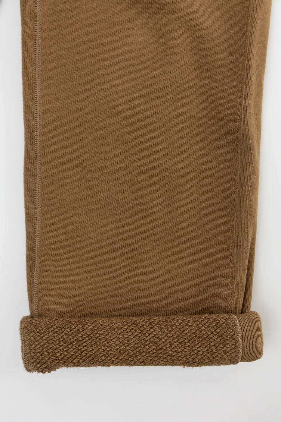 Close-up of cuff and fabric texture on front lower leg of dune double heavyweight French terry sweatpant