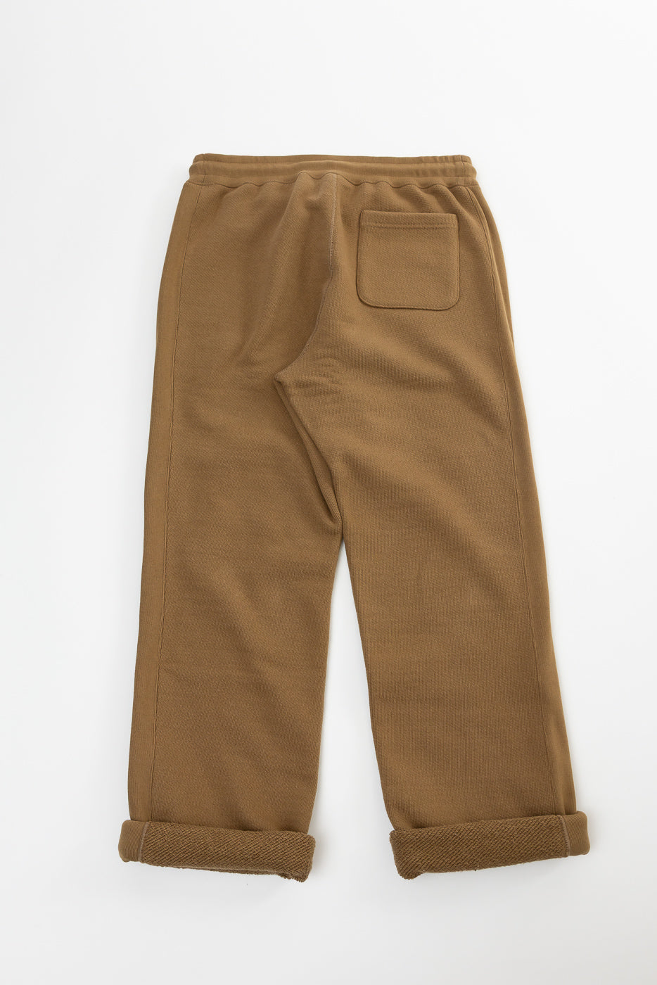 Flat lay of Dant Wonder Looper double heavyweight French terry sweatpants, back view, showing rear pocket and rolled cuffs.