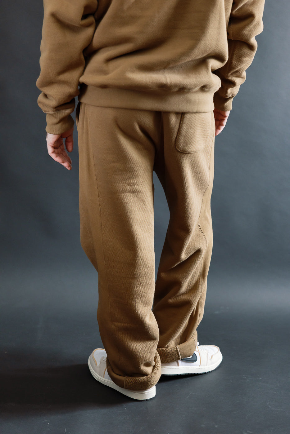 Back view close-up of Wonder Looper double heavyweight French terry sweatpant in dune on male model, 5'9