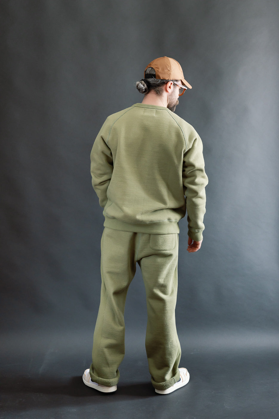 Male model 5'9 165lbs athletic build in sage Wonder Looper sweatpant, back full body view