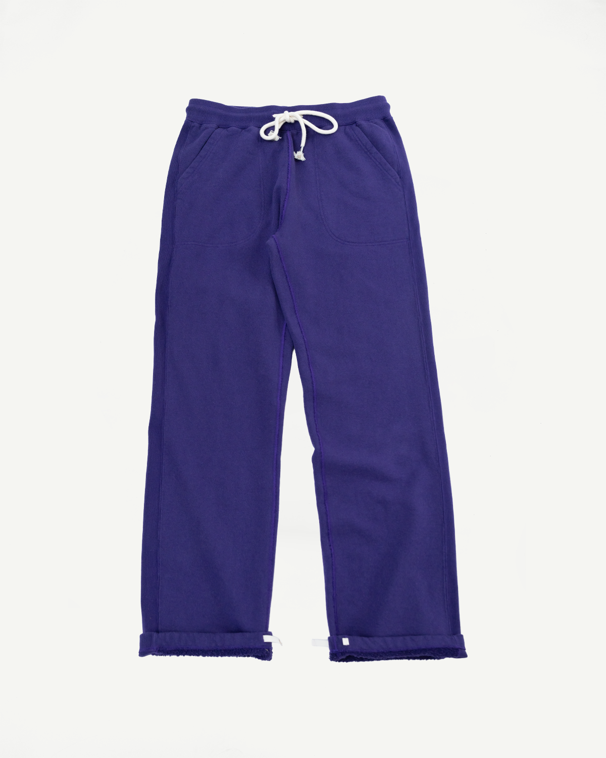 Front view of purple wide-leg sweatpants with white drawstring, side pockets, and cuffed hems