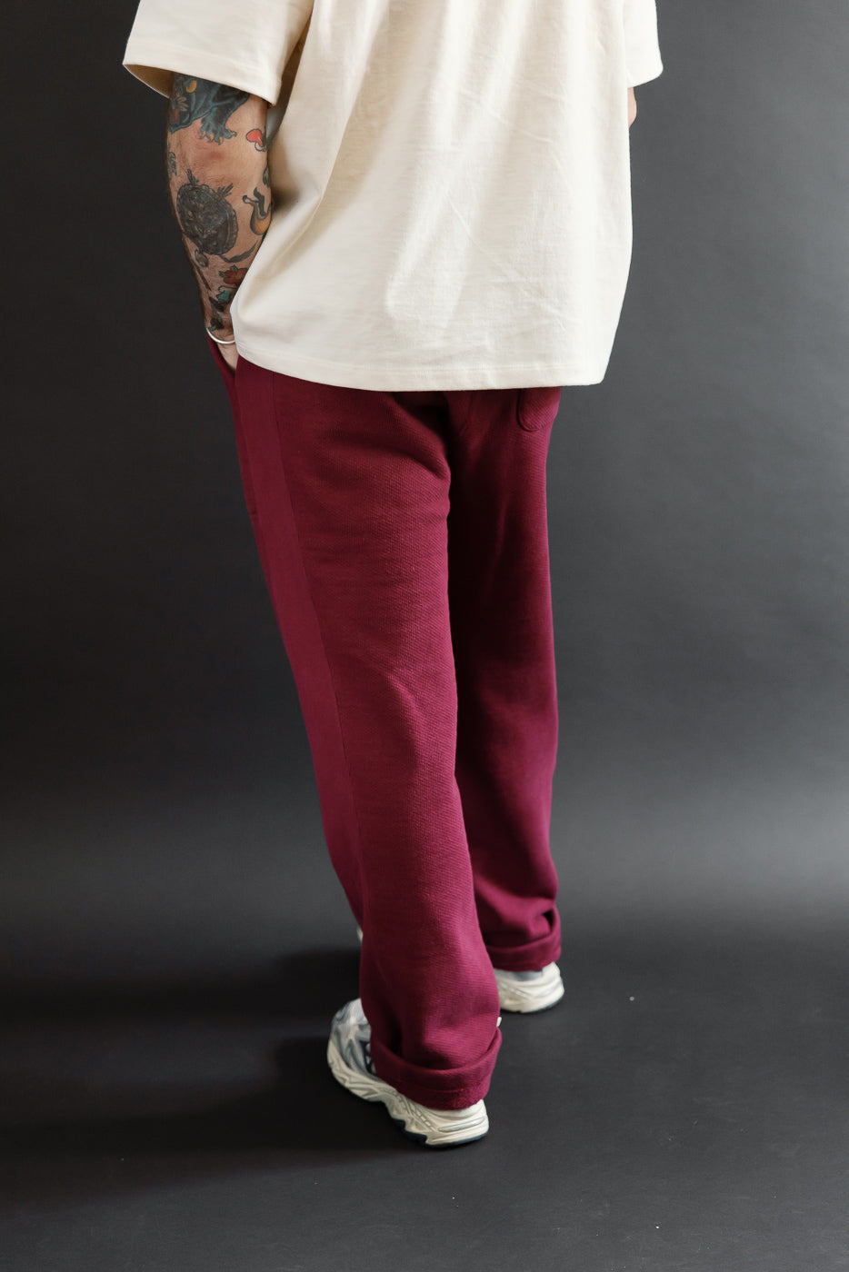 Rear view of burgundy pants on a 5'9