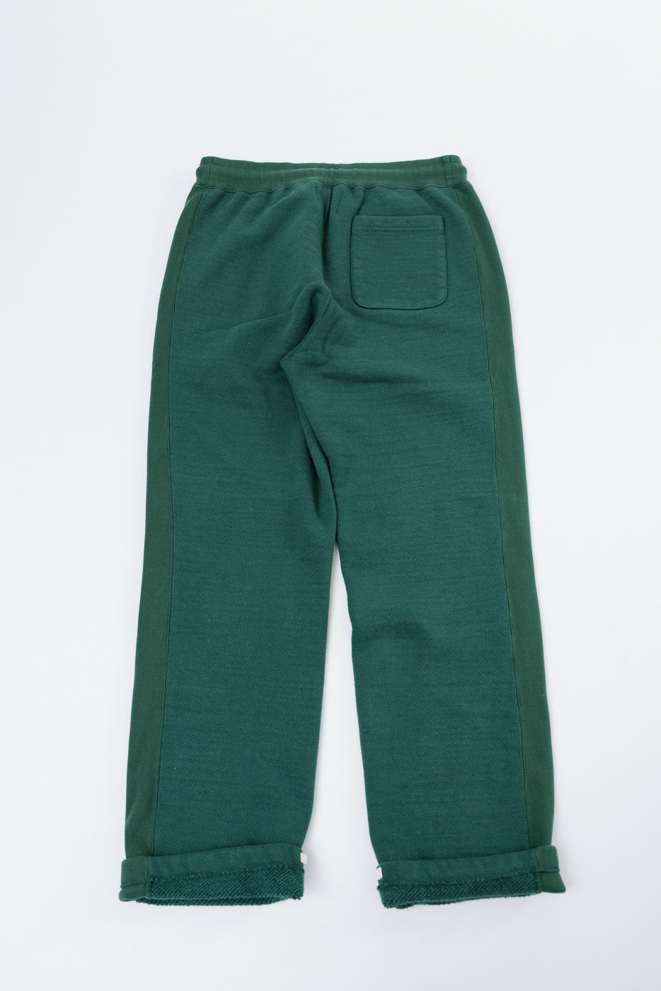Back view flat lay of green casual sweatpants with back pocket and side stripes.
