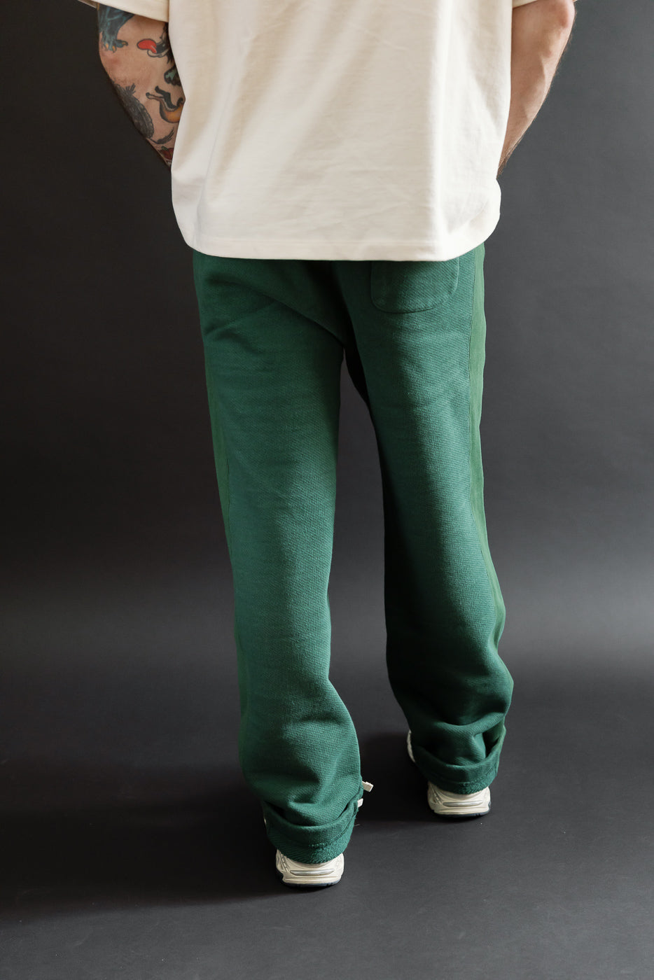 Back view of dark green pants on a 5'9