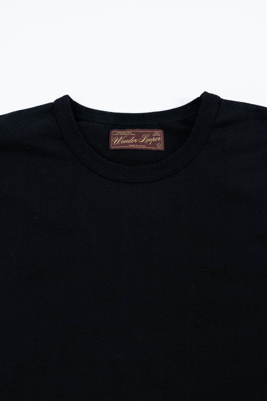 Ultimate Pima Tsuriami Crewneck T-Shirt - Black, featuring a smooth, lightweight fabric with ribbed neckline and Wonder Looper – Made in Japan label, laid flat against a white backdrop.