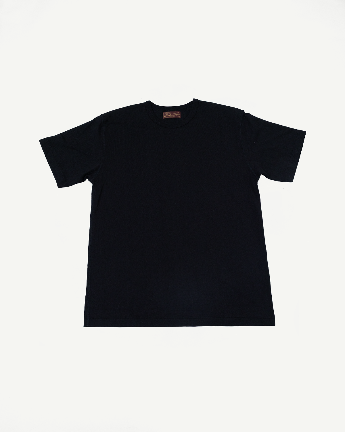 Flat lay of the front of a black short-sleeve t-shirt with a crew neck and inner neck tag.