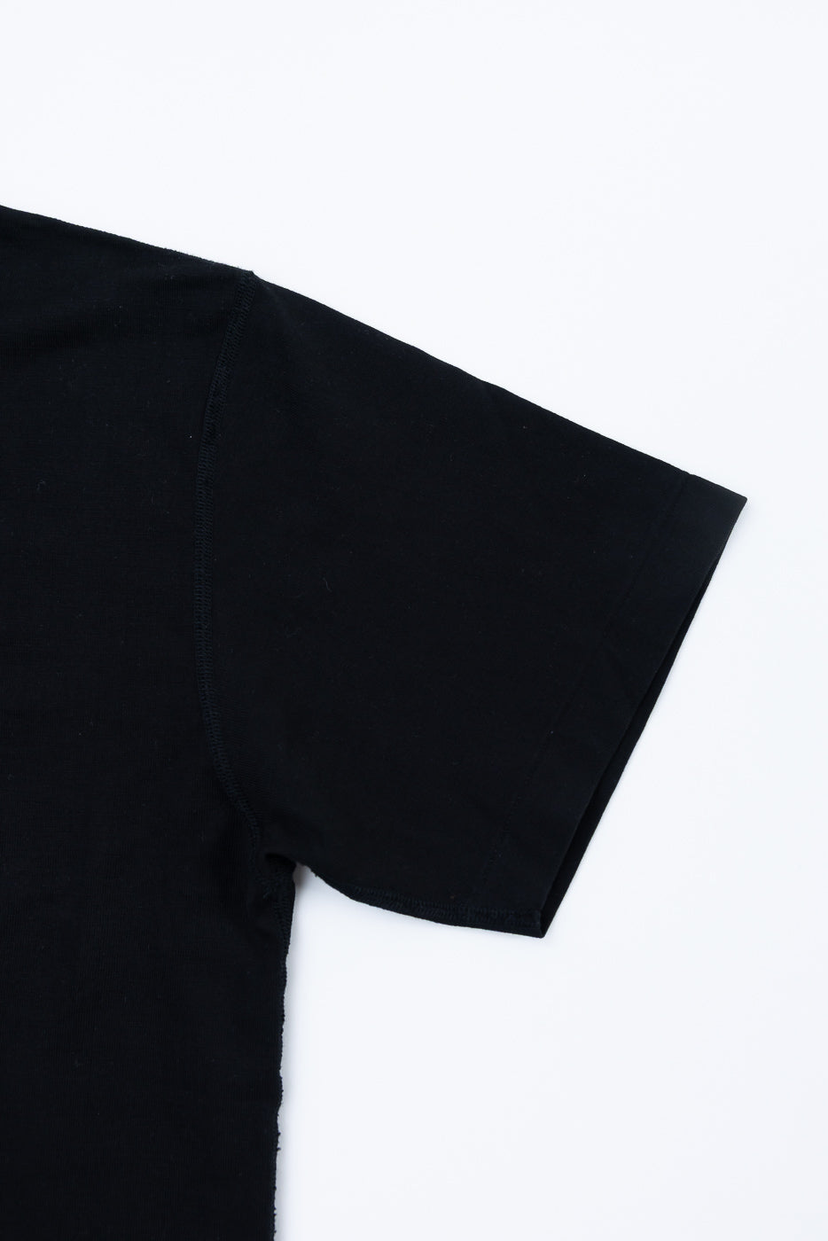 Ultimate Pima Tsuriami Crewneck T-Shirt - Black, featuring a smooth short sleeve and shoulder detail, showcasing the premium organic cotton fabric's fine texture, laid flat against a white background.
