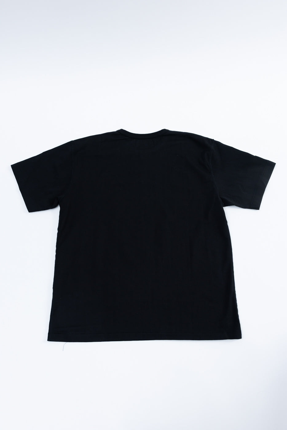 Ultimate Pima Tsuriami Crewneck T-Shirt - Black, a plain black short-sleeve tee with a crew neck, laid flat showcasing its smooth texture and organic Pima cotton fabric, embodying premium craftsmanship.