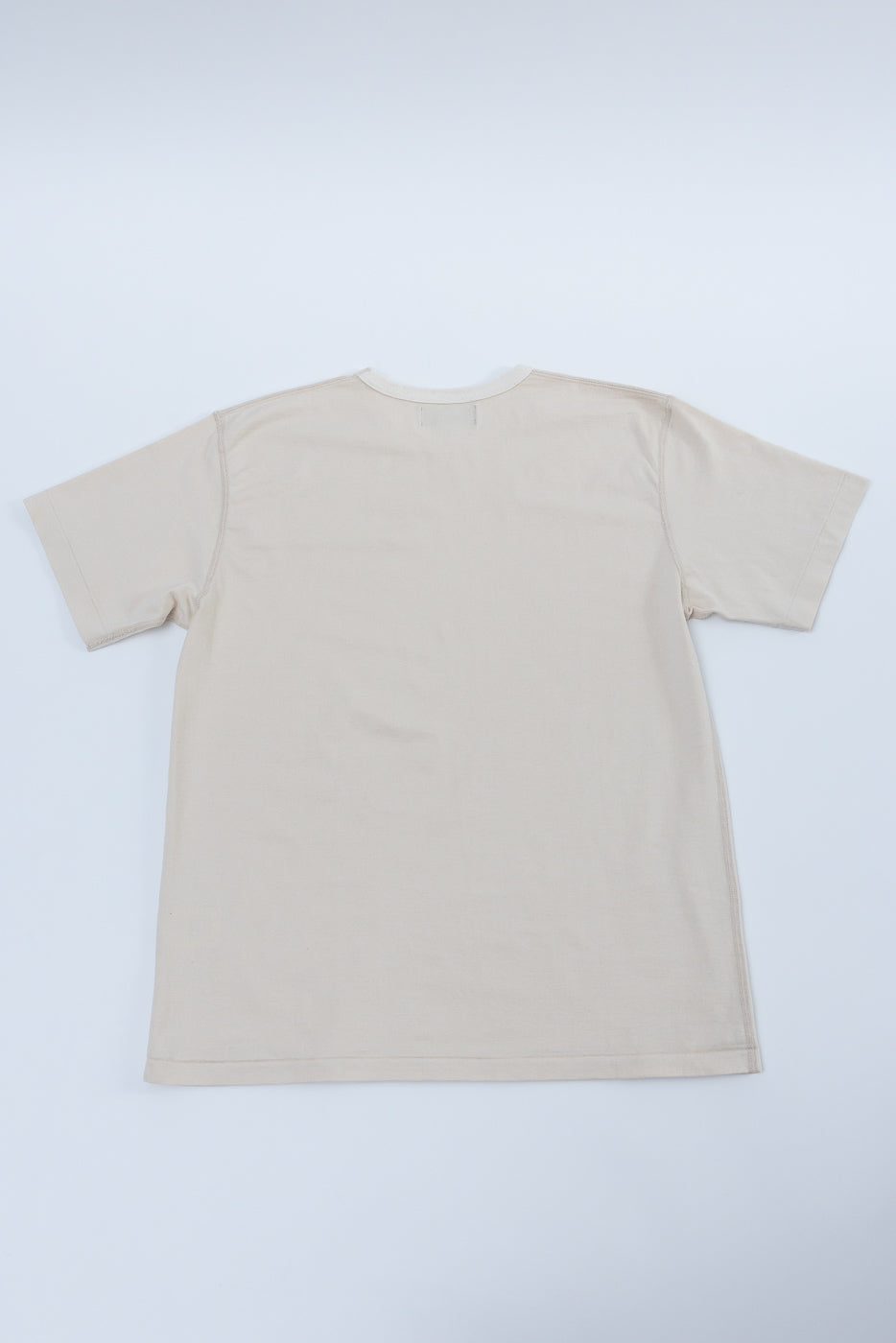 Ultimate Pima Tsuriami Crewneck T-Shirt - Ecru, shown flat with back facing up, highlighting its smooth texture and lightweight design.