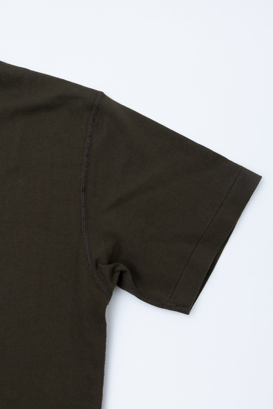 Ultimate Pima Tsuriami Crewneck T-Shirt - Khaki, showcasing its smooth shoulder seam and sleeve hem. The fabric is a dark olive, military green, highlighting its luxurious Pima cotton knit.