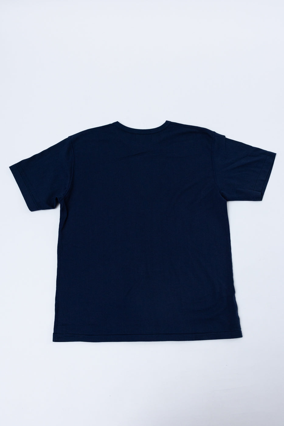Back view flat lay of a navy blue short sleeve crewneck t-shirt.