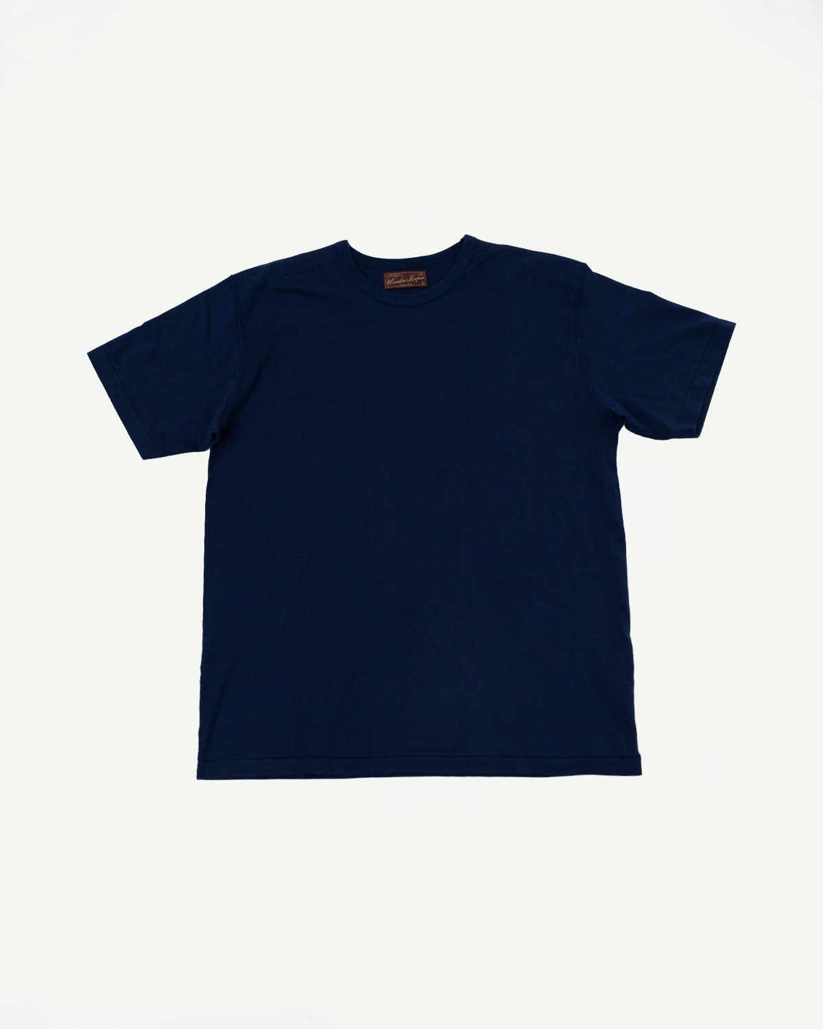 Flat lay of the front of a navy blue short-sleeve t-shirt with a crew neck and inner tag.