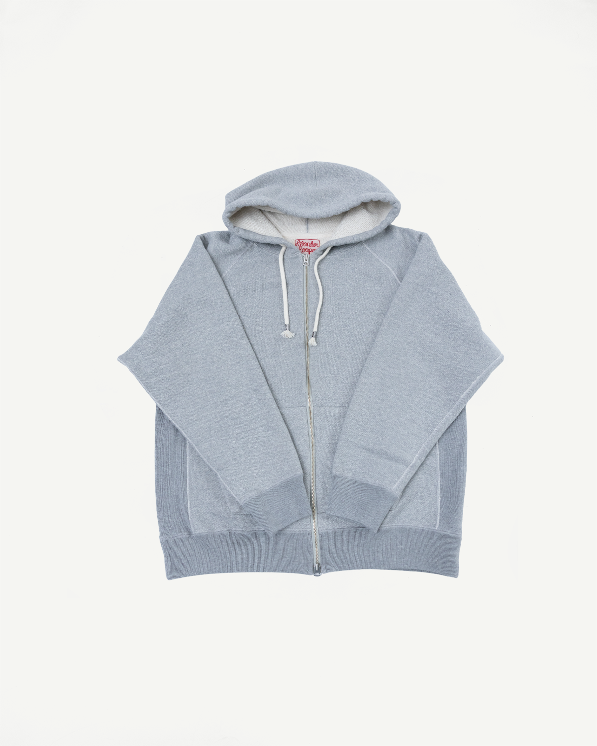 Front view flat lay of a grey zip-up hoodie with a red brand tag on the inner collar.