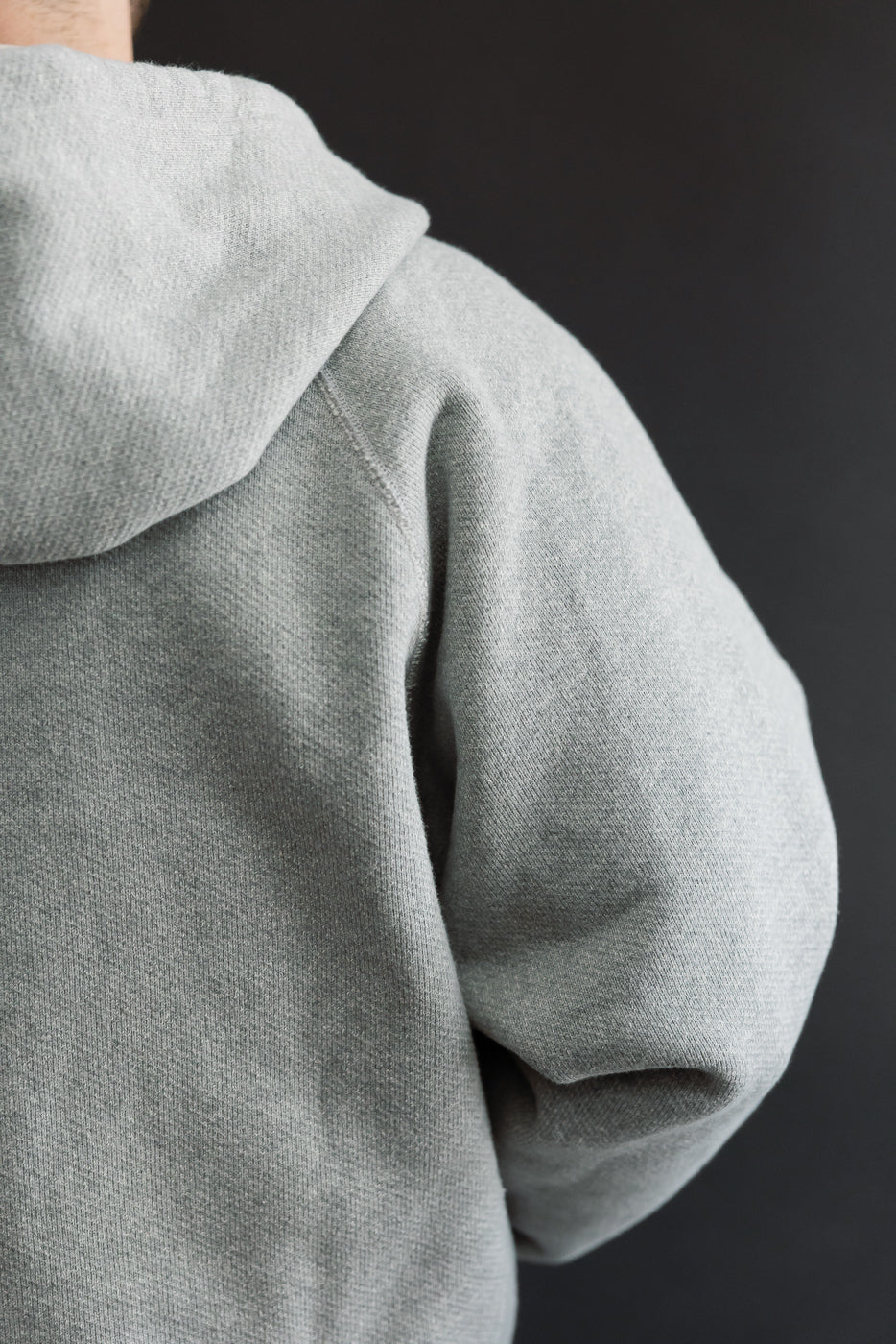 Close-up back view of a grey hoodie on a 5'9