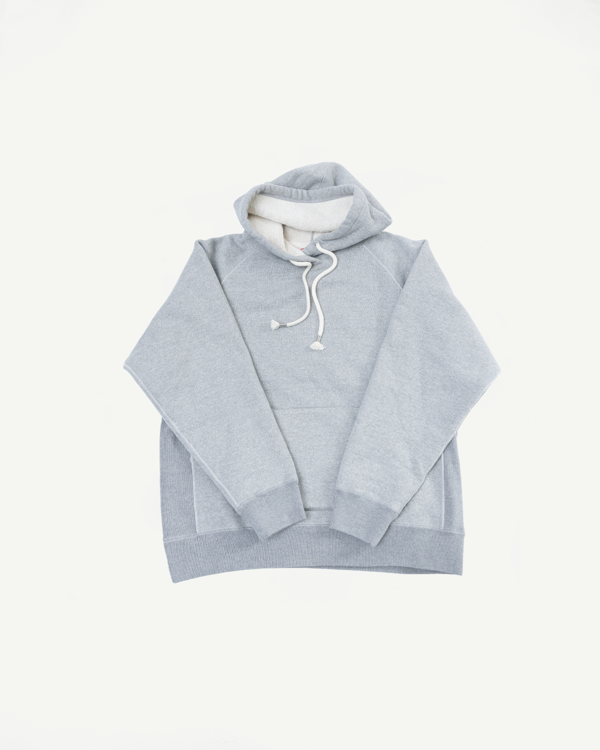 Front view flat lay of a light grey fleece hoodie with white drawstrings.