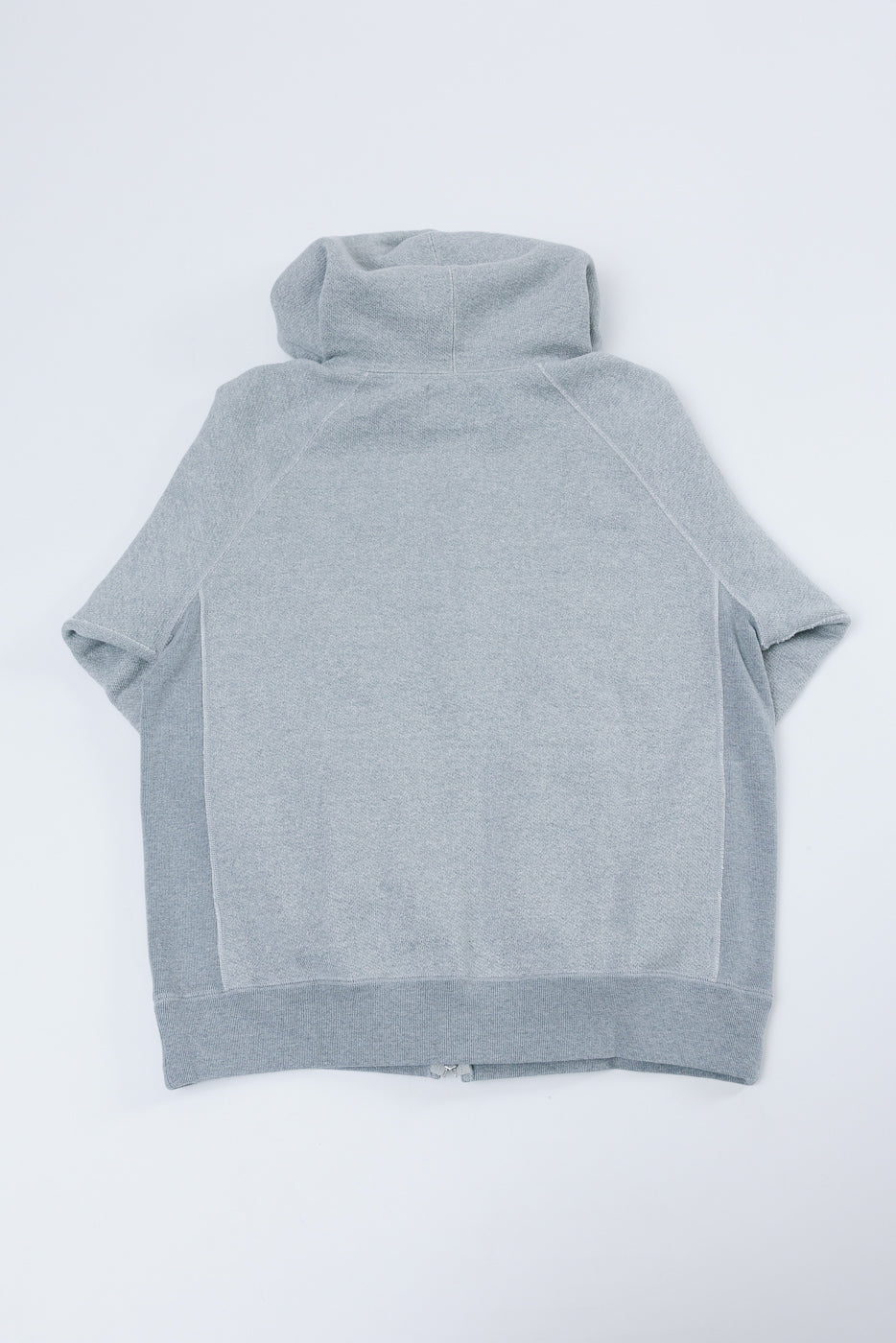 Back view flat lay of a grey high-neck sweatshirt with raglan sleeves and a ribbed hem.