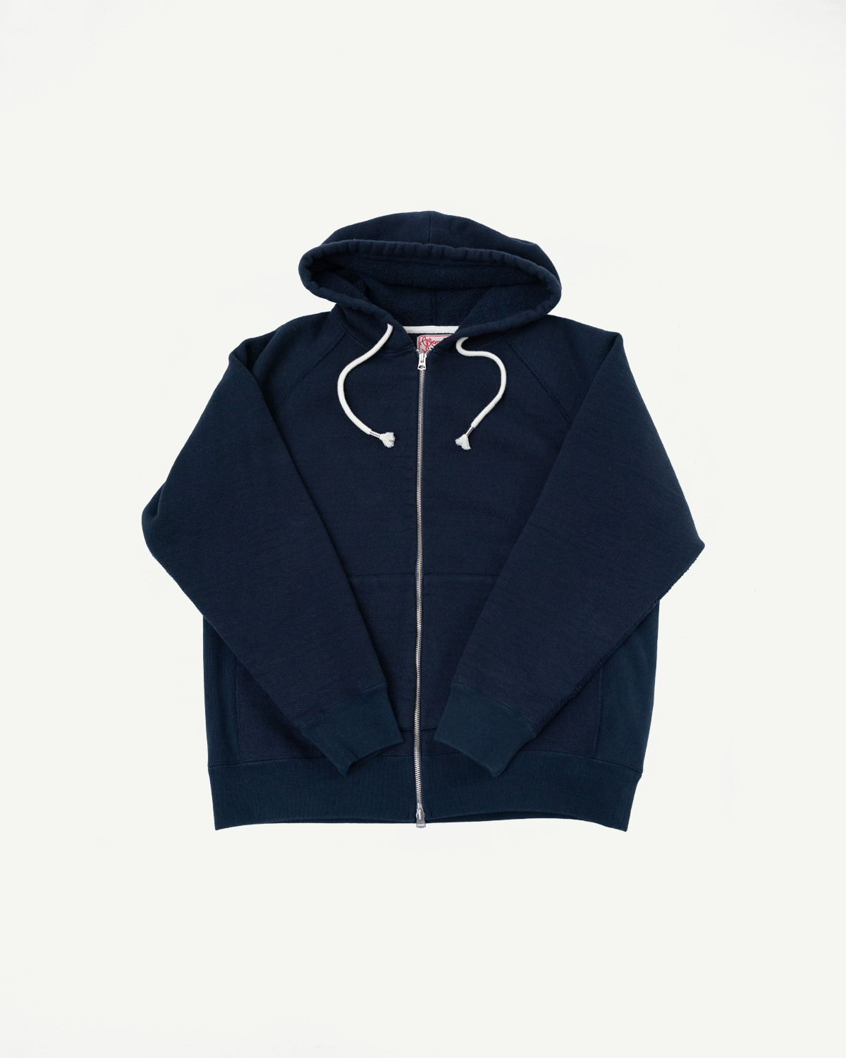 Front view flat lay of a navy blue zip-up hooded sweatshirt with white drawstrings.