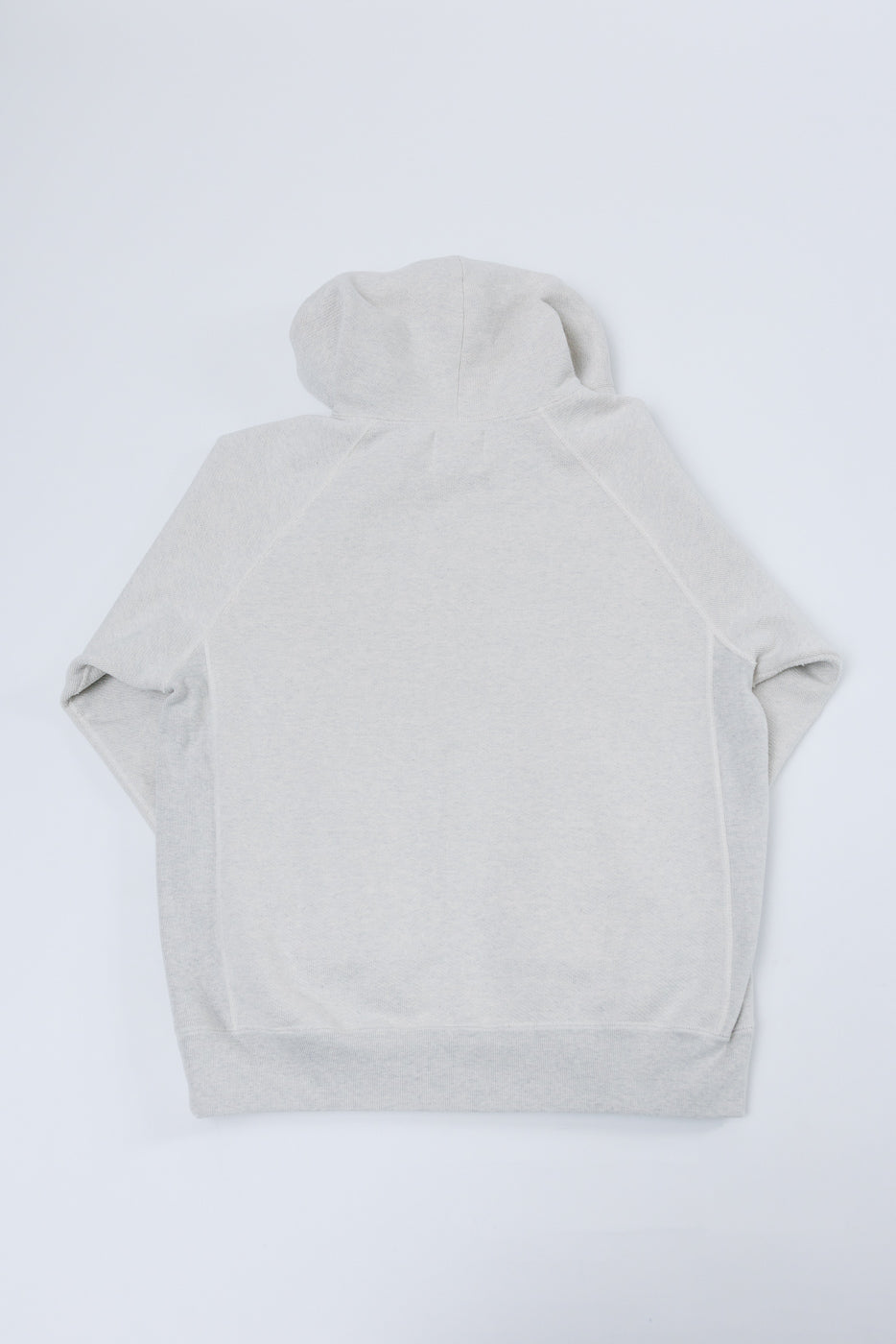 Back view flat lay of a light grey hooded sweatshirt showing the hood and hem.
