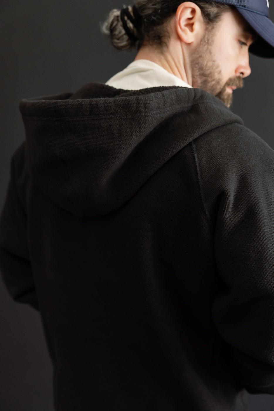Back view of a dark brown fleece hoodie worn by a 5'9