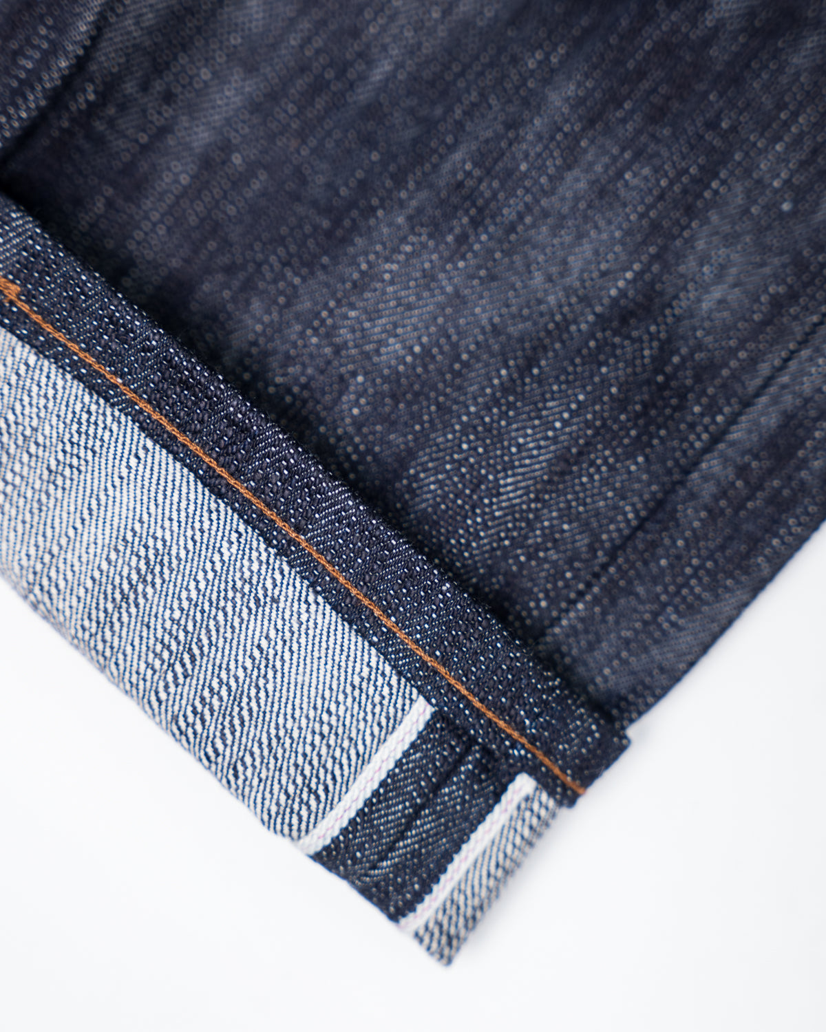 Close-up of Naked & Famous 18oz Big Slub Selvedge denim cuff showing selvedge edge and stitching