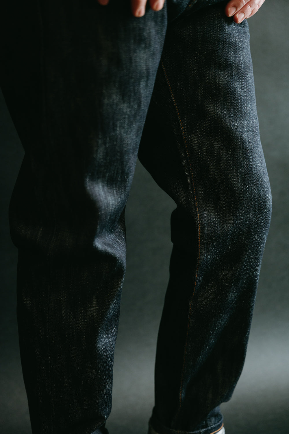 Close-up of men's selvedge denim jeans front thigh on male model, 5'9